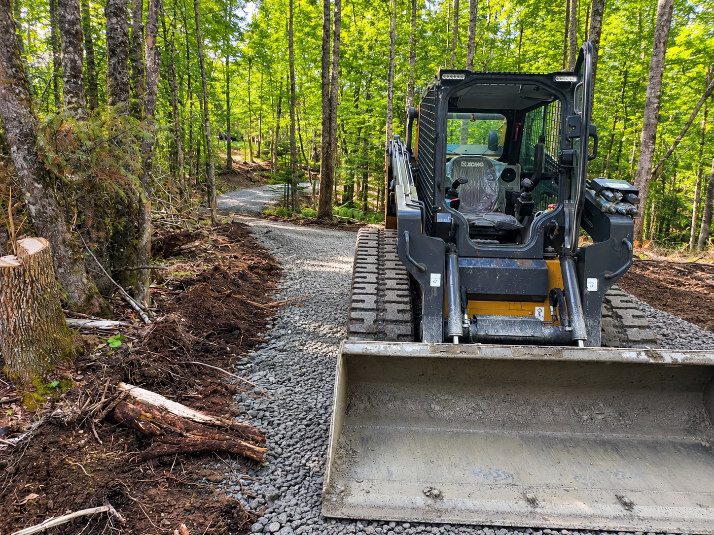 Excavation and gravel driveway site preparation with tracked loader