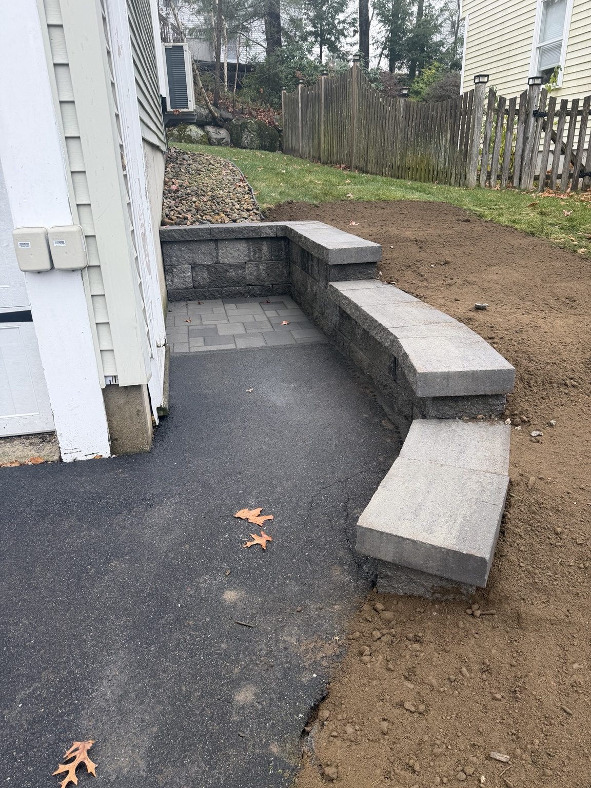 Curved retaining wall beside home