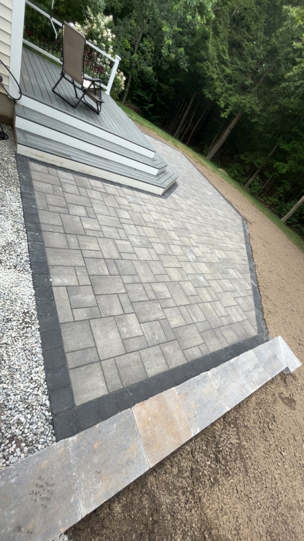 Paver patio beside deck