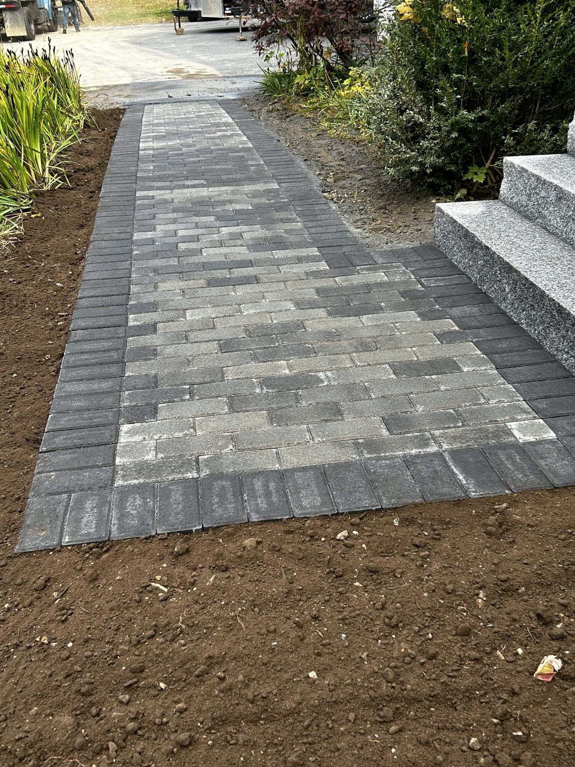Gray paver walkway with dark border